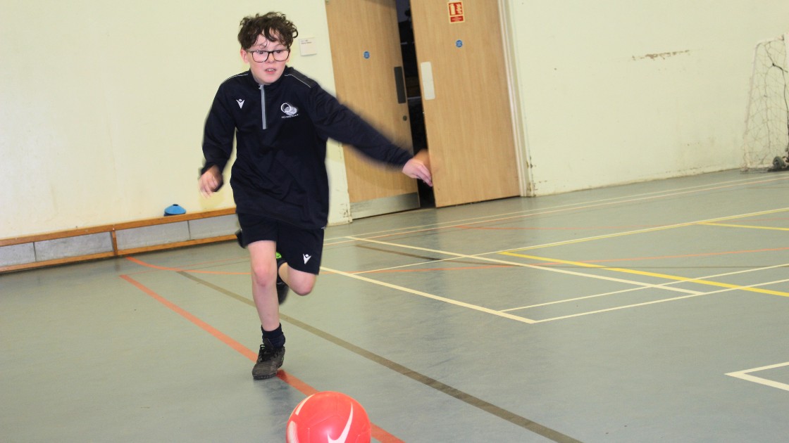 One of the students taking a free kick.