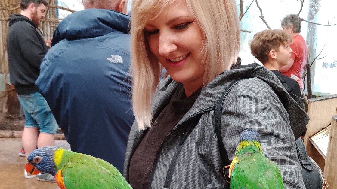 Miss Smith enjoys the company of some lorakeets!