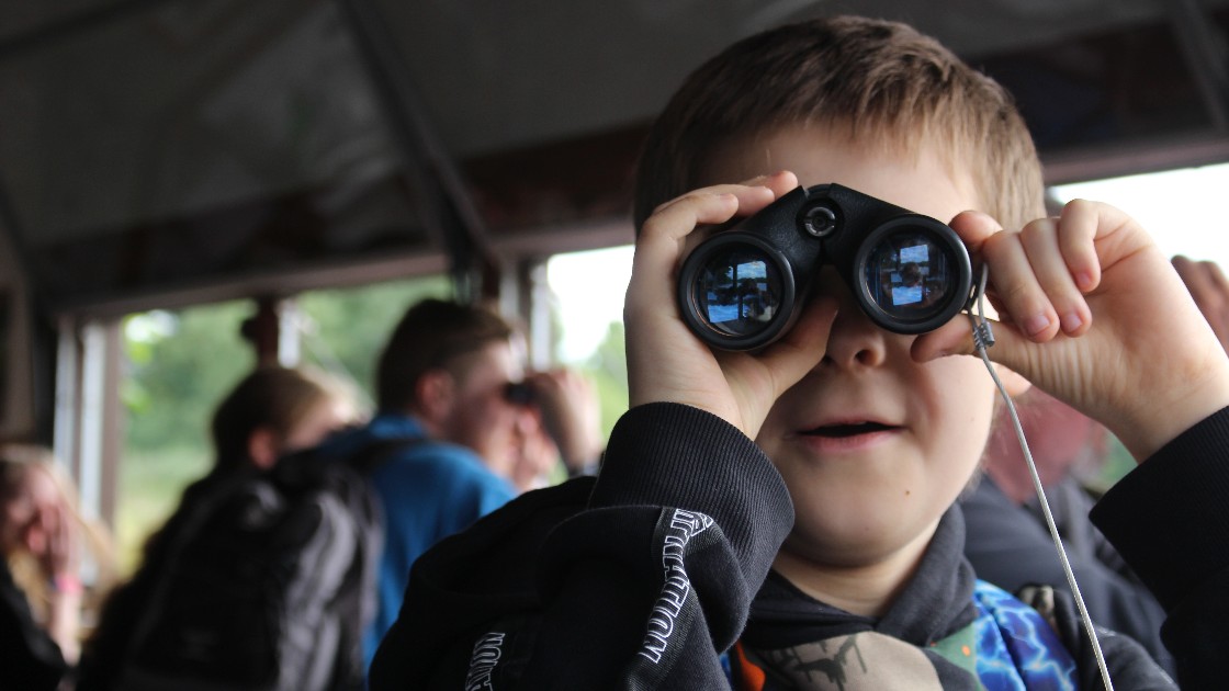 Student holding binoculars