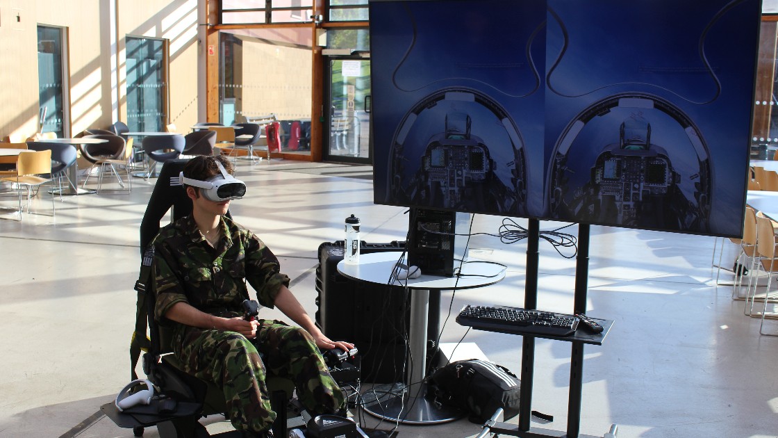 A cadet showcasing the VR flight simulator.