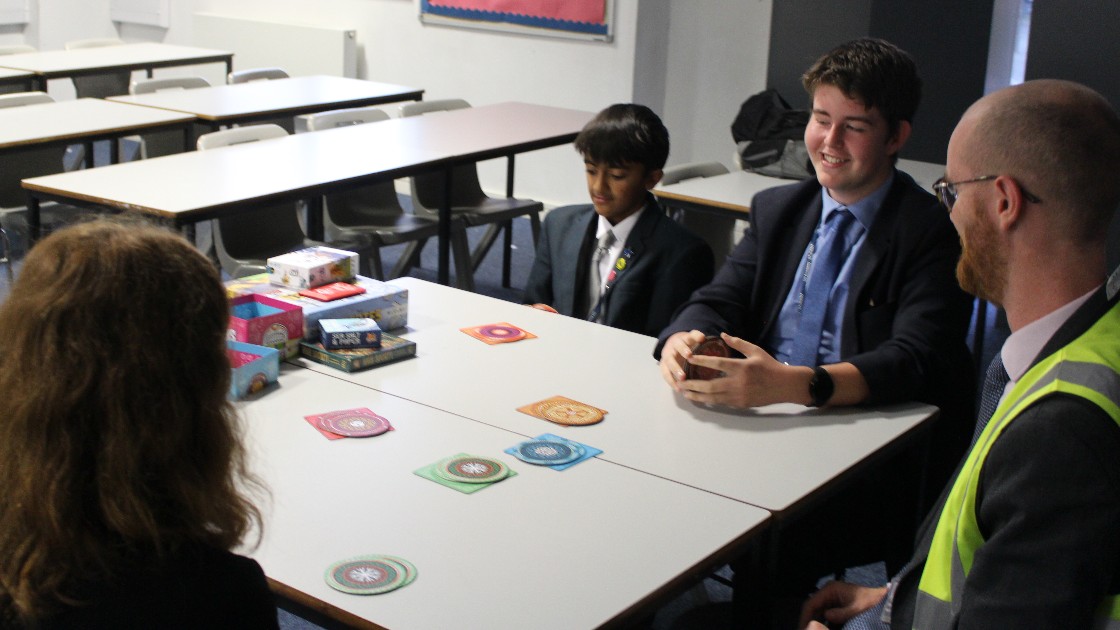 Students playing a bluffing game called 'Skull'.