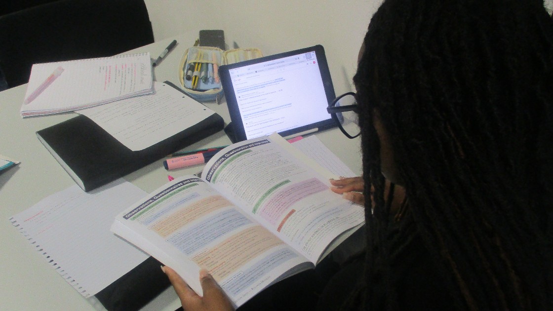 A student reading their textbook and study in the study room