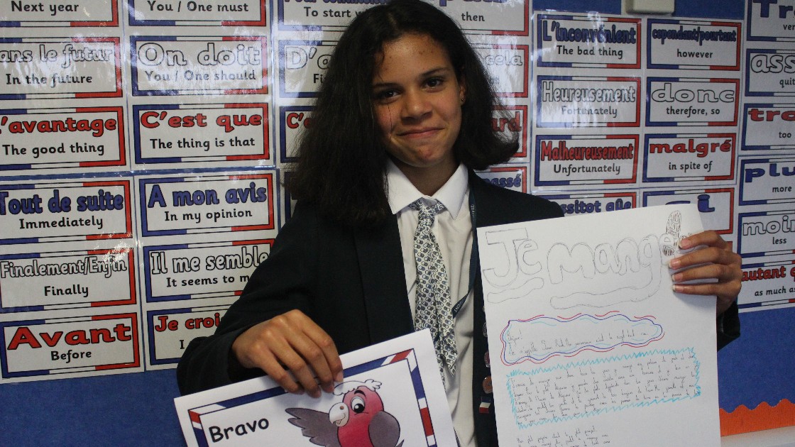 Proud students posing with her work and reward