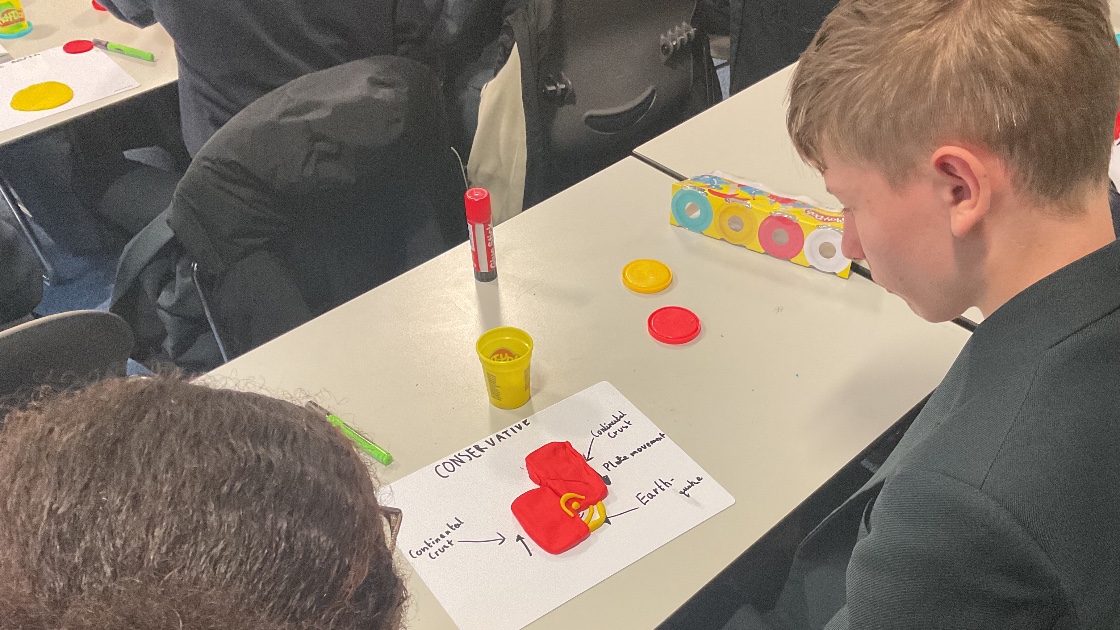 Students looking at a play dough model