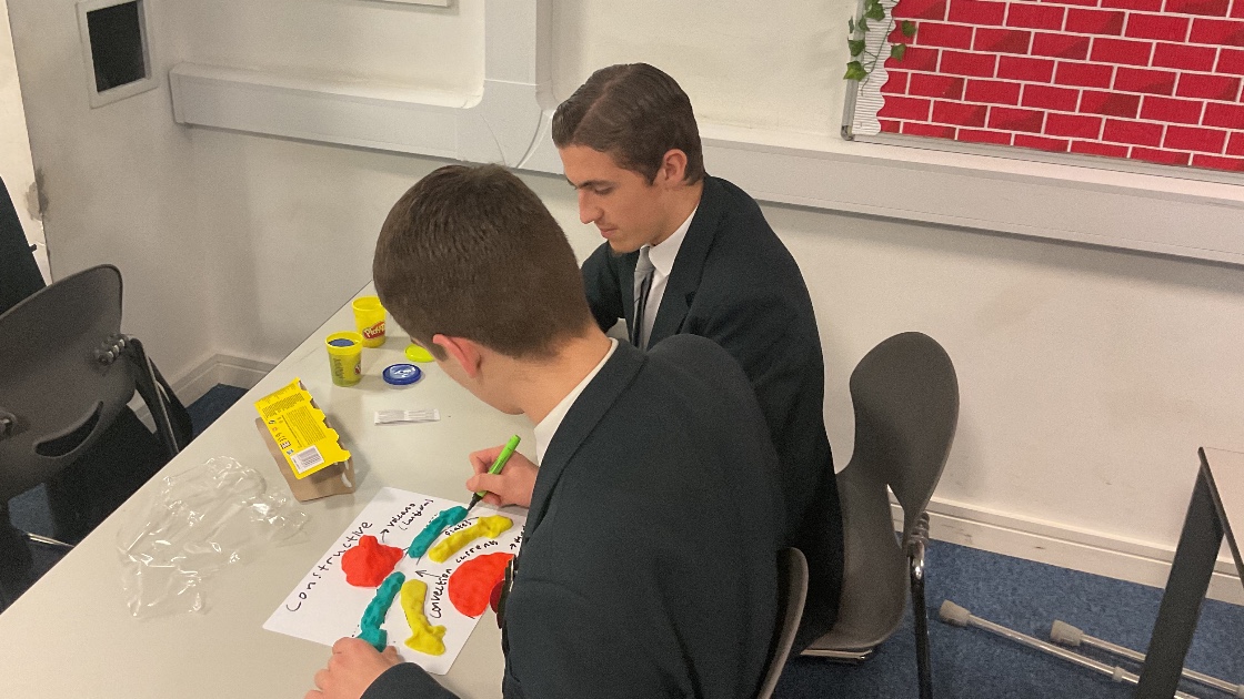 Boy annotating a play dough model