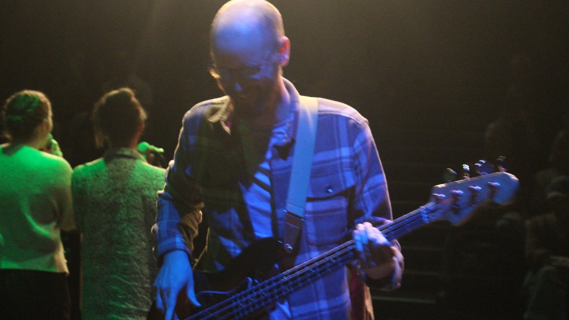 A member of staff performs bass