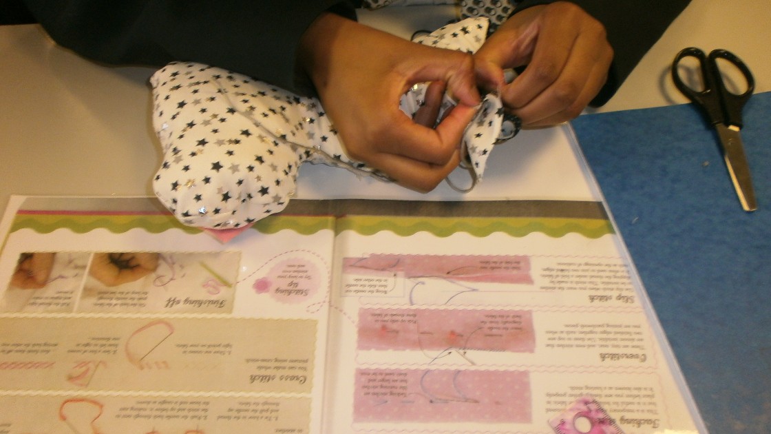 Student completing embroidery stitches.