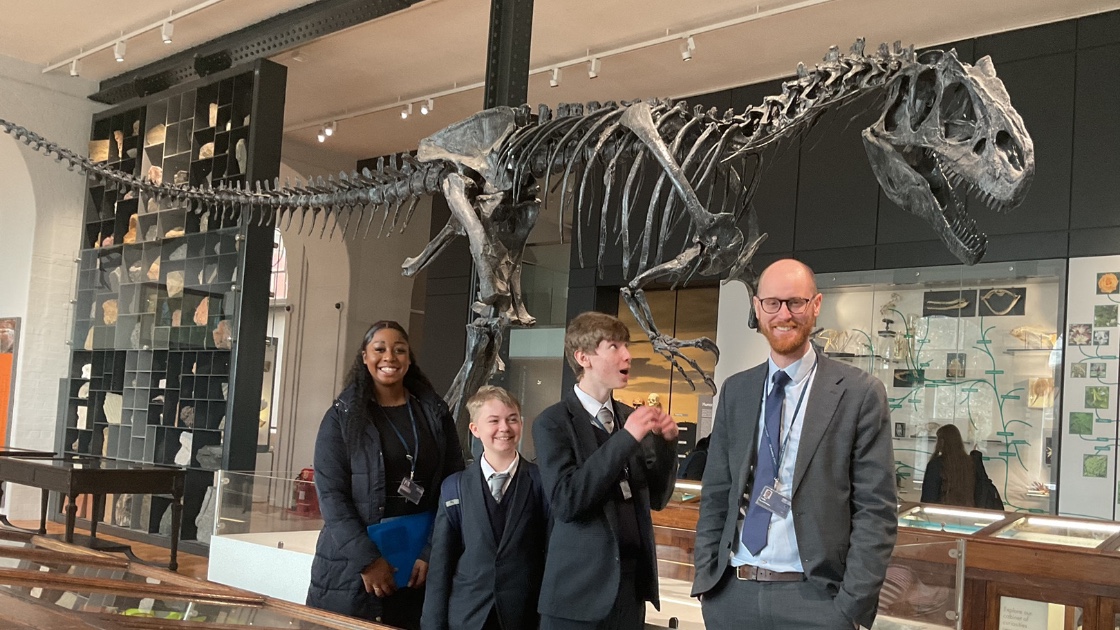 Teachers and students by a dinosaur