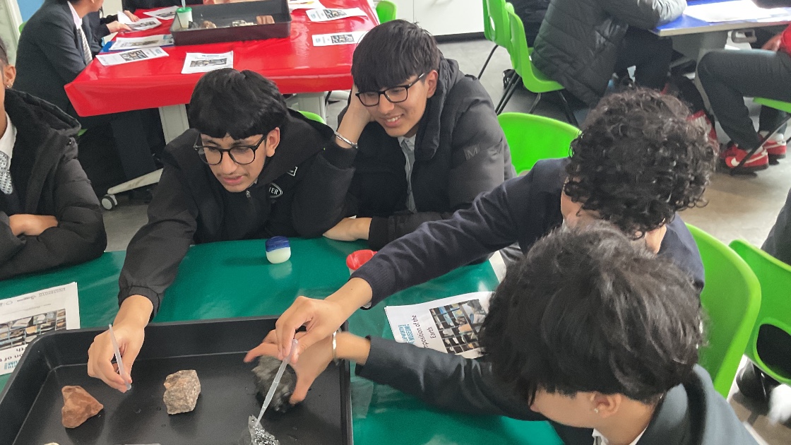 Students using a pippet to check the porosity of rocks