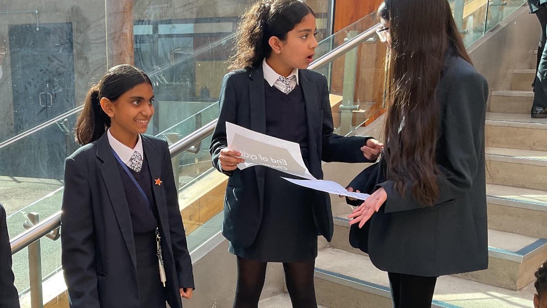Three female students discussing the task