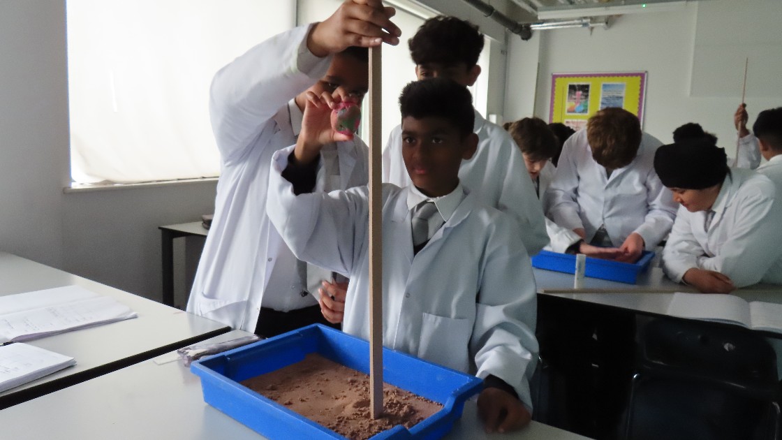 Students dropping an asteroid from a set height.