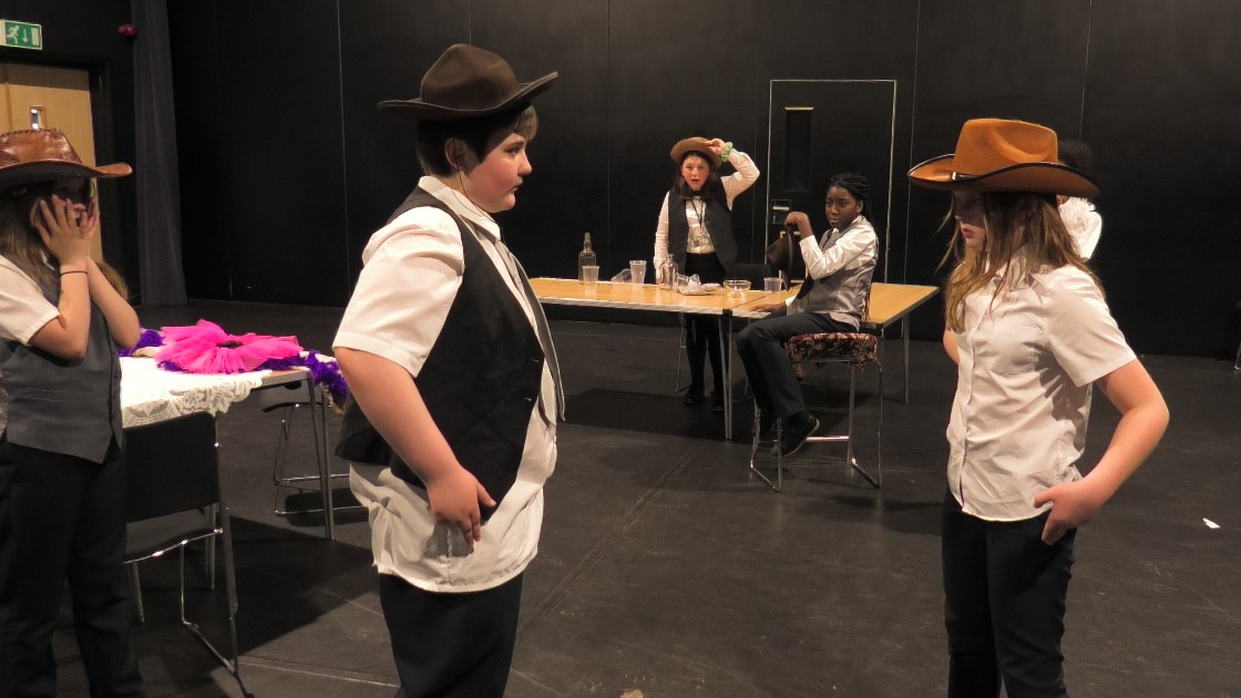 Students acting out a scene from their Western.