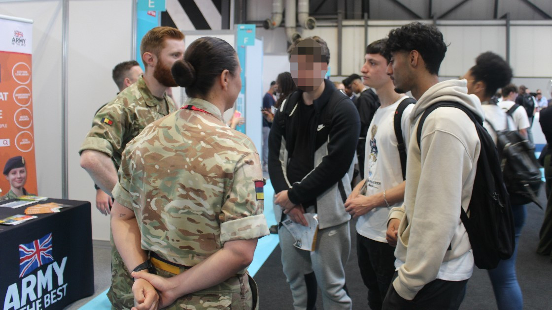 Students engaging in conversation with the Army.