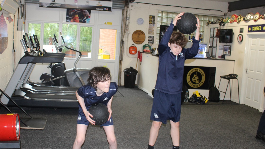 Students using the heavy ball.