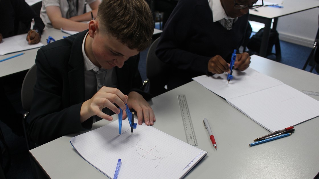 Two of our year 10 students using compasses