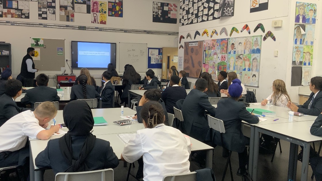 Students in a classroom watching a presentation on a screen