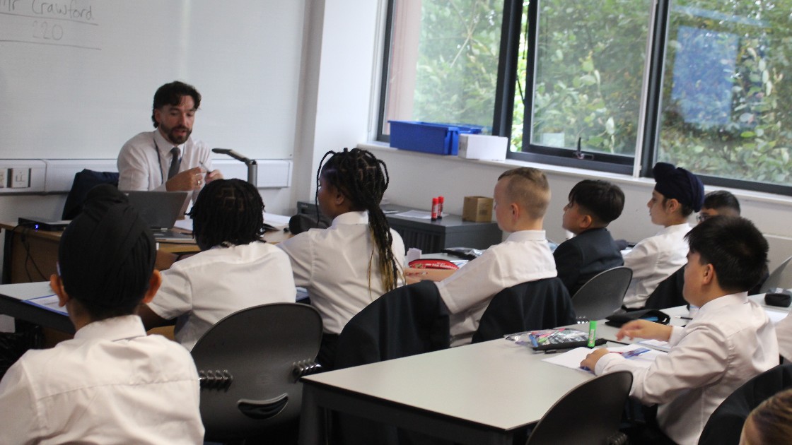 A teacher conducting a lesson with Year 7 students in a classroom