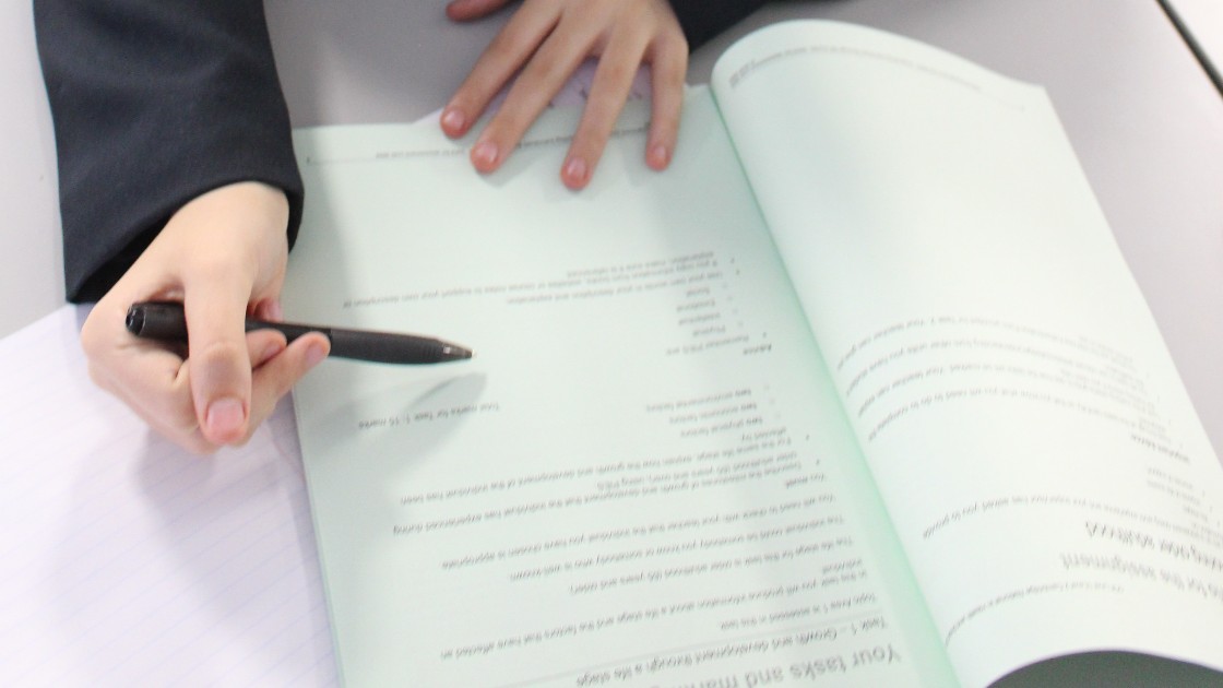 Students examining the set assignment during a Health & Social Care lesson