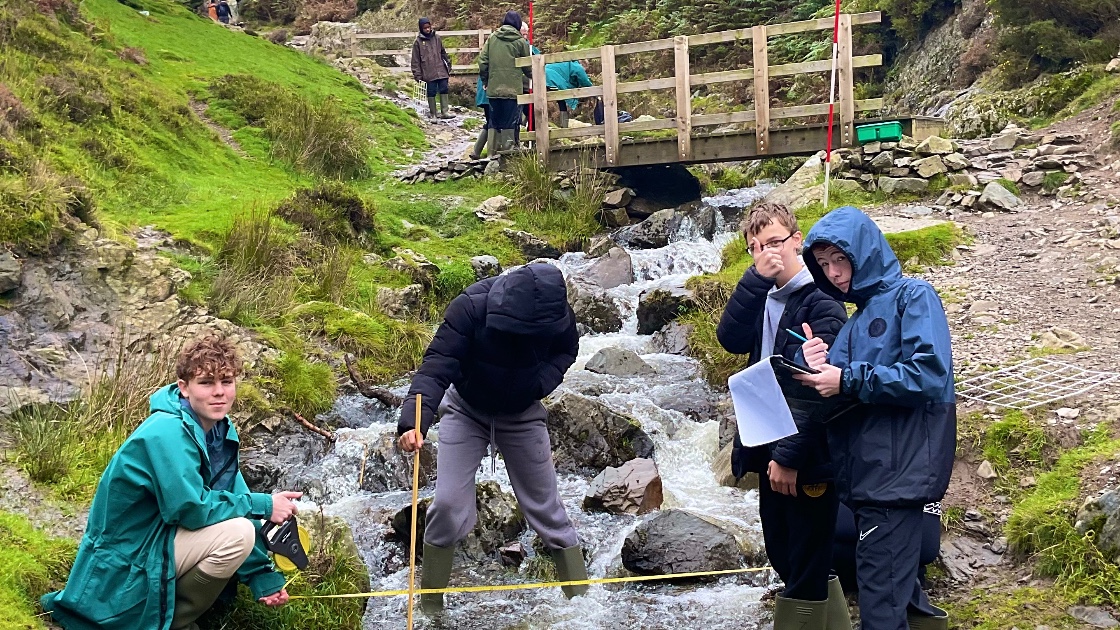 Students measuring a stream in Carding Mill Valley