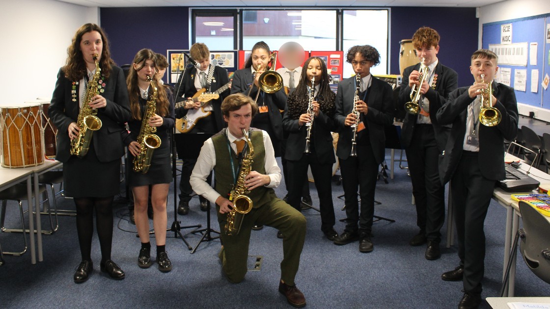Students playing musical instruments in a classroom