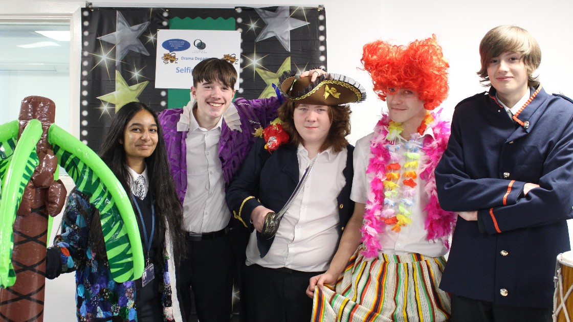 Group of students in costumes posing for a photo