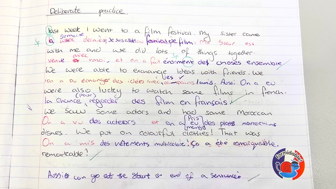 A student's handwritten French exercise with corrections and annotations