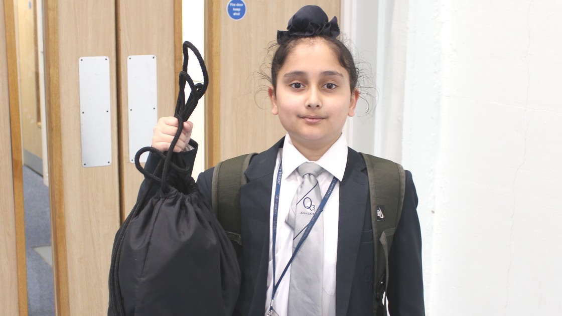Student holding their Sports Kit in a bag