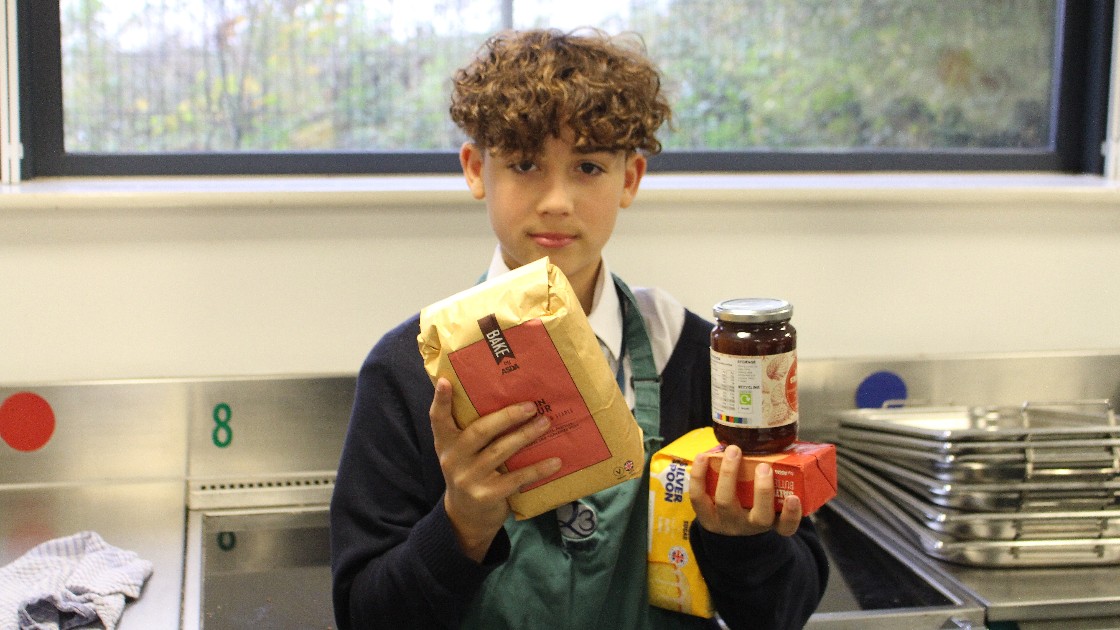 Student holding cooking ingredients