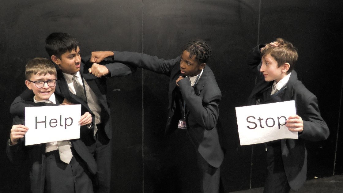 Four students acting out a scene
