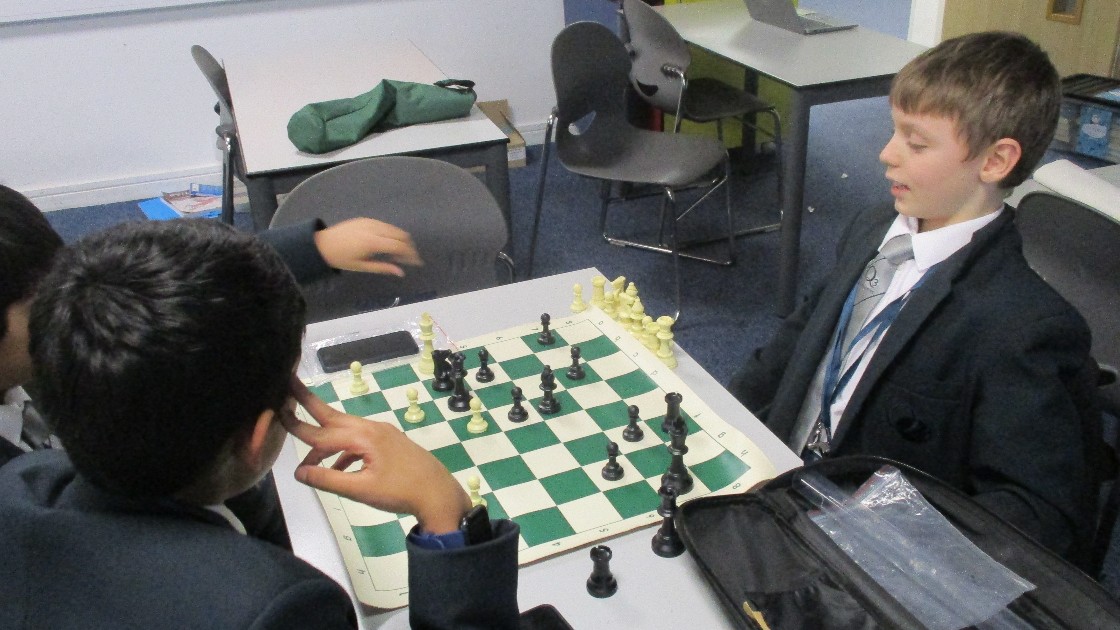 Students playing chess at Q3 Chess Club