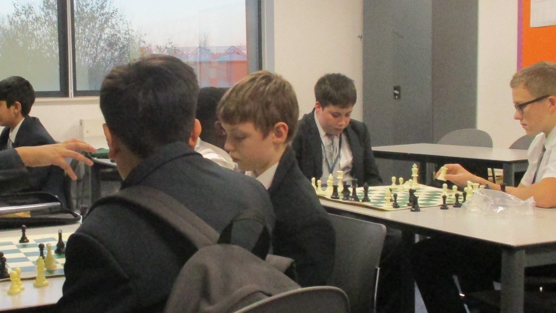 Students playing chess in a classroom setting