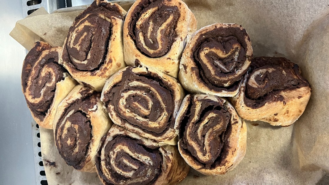 Freshly baked chocolate swirl pastries on parchment paper