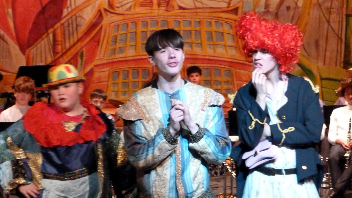 Students performing in a Treasure Island pantomime, wearing colourful costumes