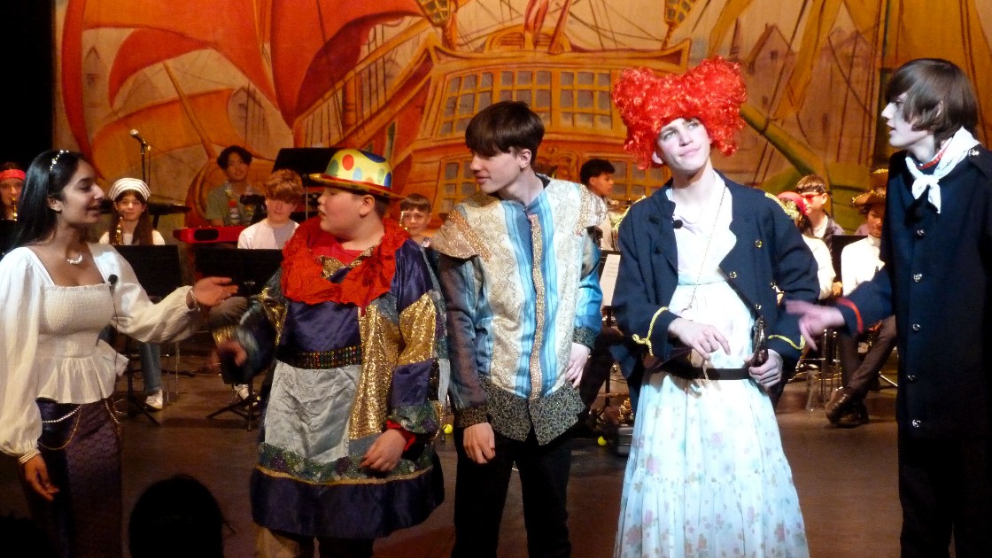 Students performing in a Treasure Island pantomime on stage