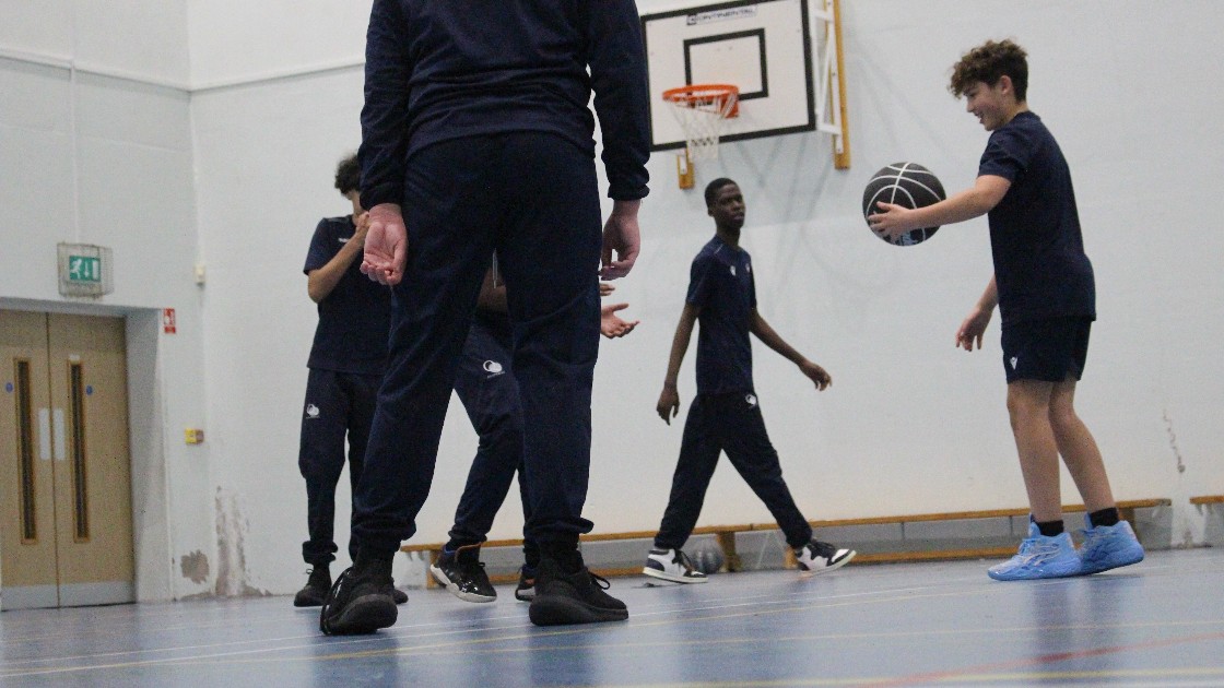 Students playing basketball in a school gym
