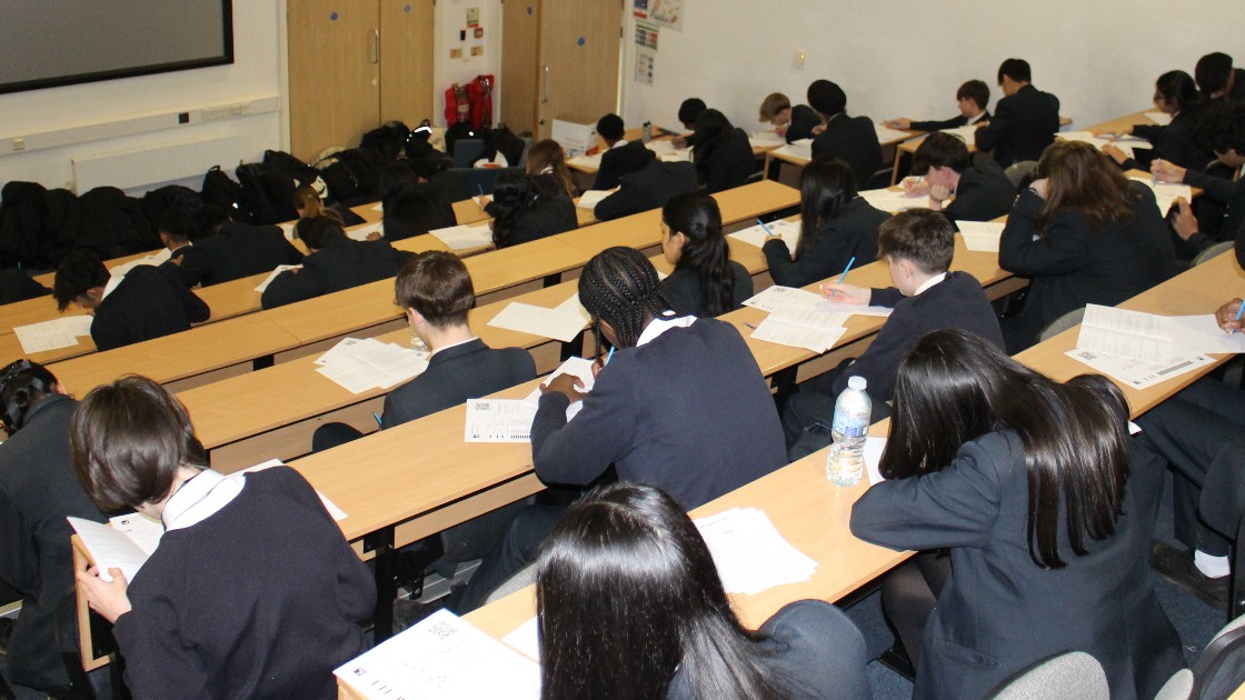 Students seated in a lecture hall taking a written test
