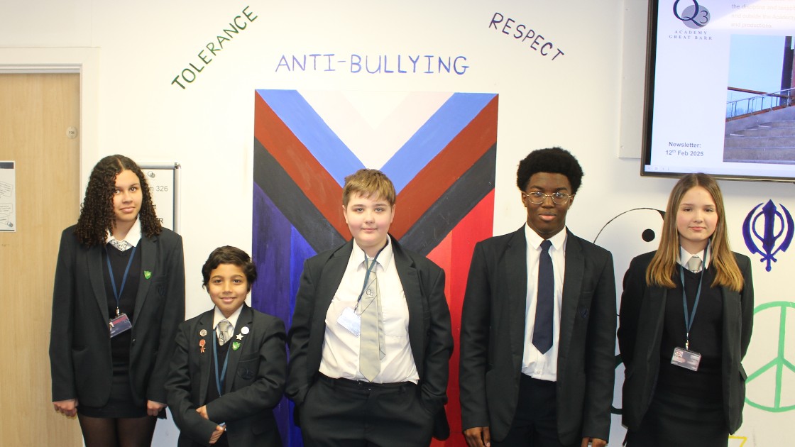 Students standing in front of anti-bullying display