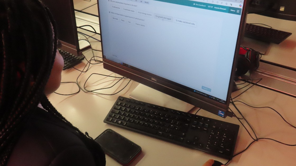 A student working on a computer in a classroom