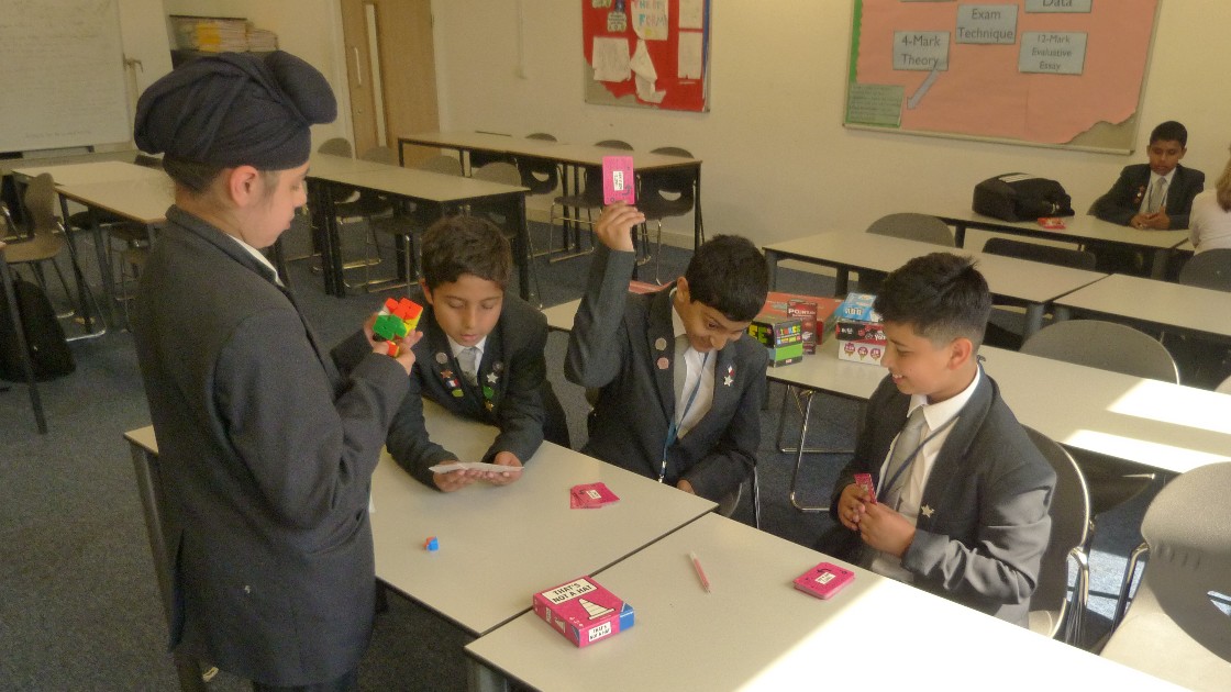 Students playing board games at a table in a classroom